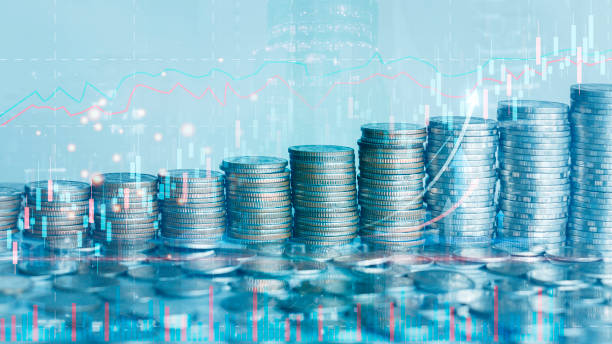 istock Coin piles with forex chart interface and arrow on blurry city background. Money and stats concept. Double exposure 1430371597