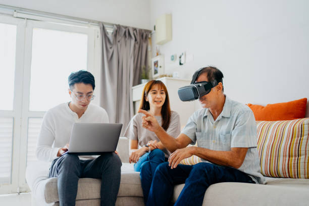 Senior man using VR headset at living room