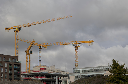 A view of working tower cranes on a construction site in Dublin City Ireland