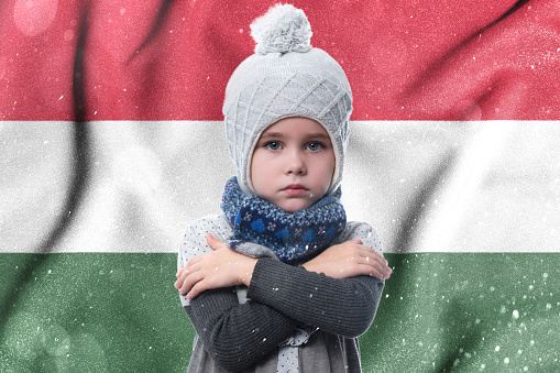 Hungary and the gas winter crisis, high gas tariffs for the population, the girl is frozen, the child without heat in winter hugs himself with his arms to keep warm.