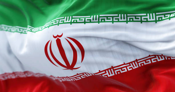 Close-up view of the Iran national flag waving in the wind Close-up view of the Iran national flag waving in the wind. The Islamic Republic of Iran is a State of Asia located at the eastern end of the Middle East. Fabric textured background. Selective focus tehran stock pictures, royalty-free photos & images