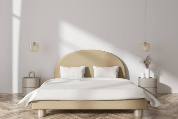 istock Front view on bright bedroom interior with bed, bedsides, pillows 1430377706