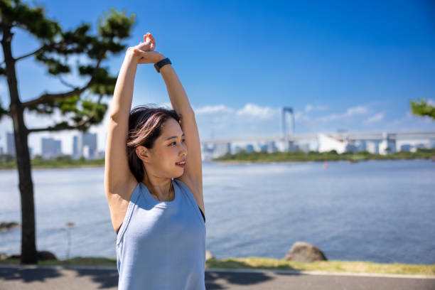 istock Female athlete stretching in public park 1430379875