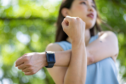 Female athlete training in public park, stretching, doing boxercise, jogging, and taking a break