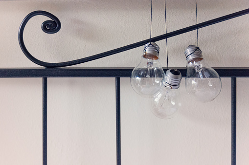 Three lightbulbs hanging over the bed