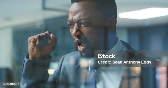 istock Shock, frustrated and angry businessman at window in his office standing to hit the glass with stress. Upset, burnout and agro professional black company manager looking outside a workplace building. 1430381517