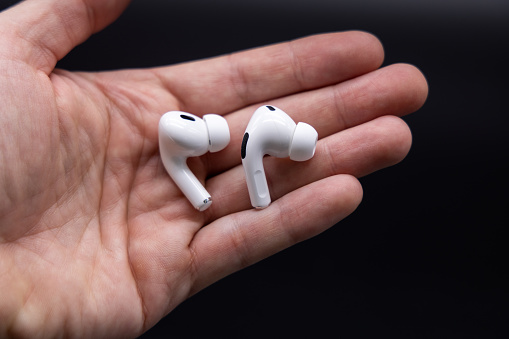 Germany - October 02, 2022: The Apple AirPods Pro 2nd generation headphones held in the palm of a hand.