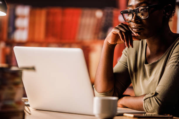 istock Young woman reading something on her laptop 1430390672