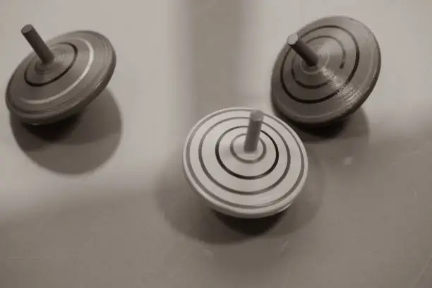 three spinning tops on black white background