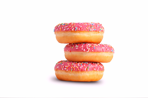 Stack of glazed donuts with pink icing. Isolated on white background. Copy space