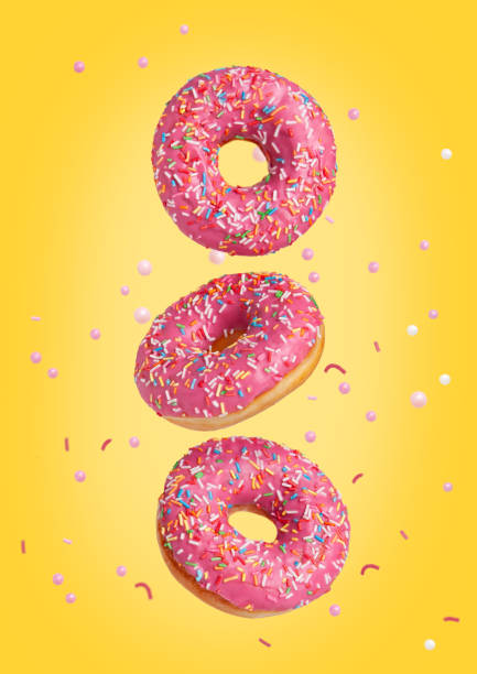 istock Three sweet pink donuts are flying in the air. 1430392354