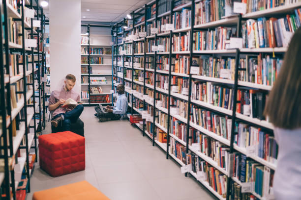 istock People chilling among bookshelves in library 1430394095