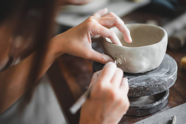 istock View of female hands works with clay makes future ceramic plate, ceramic artist makes classes of hand building in modern pottery workshop, creative people handcrafted design 1430398900