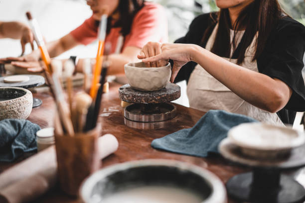 istock View of female hands works with clay makes future ceramic plate, ceramic artist makes classes of hand building in modern pottery workshop, creative people handcrafted design 1430398917