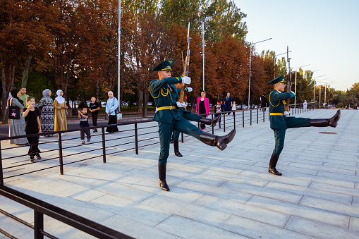 Bishkek, Kyrgyzstan - October 3, 2022: Soldiers that guarding the national flag of Kyrgyzstan are marching on the square