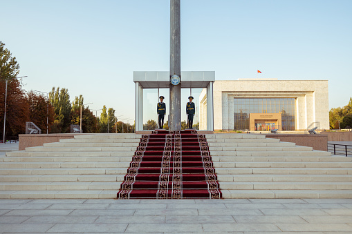 Bishkek, Kyrgyzstan - October 3, 2022: Soldiers guarding the national flag of Kyrgyzstan