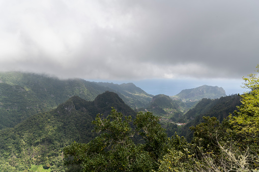 Panoramic view over the beautiful green mountains from Levada dos Balcoes, Madeira. Beautiful sunny day for hike.
