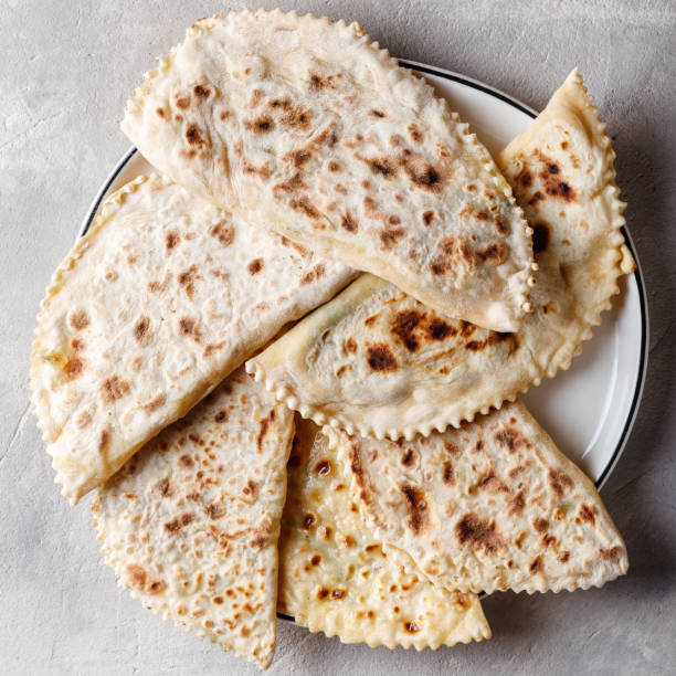 istock Delicious gourmet flat bread kutabs with herbs and cheese on a plate. Top view 1430404515