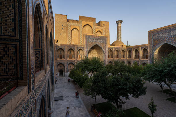 istock Inner courtyard of Ulugh Bek Madrassa, shot from the second floor during sunset with rays of light hitting the tops, Samarkand 1430407884