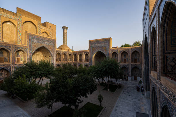 istock Inner courtyard of Ulugh Bek Madrassa, shot from the second floor during sunset with rays of light hitting the tops, Samarkand 1430407918