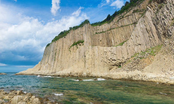 istock coast of Kunashir Island with columnar basalt cliff, Cape Stolbchaty 1430413781