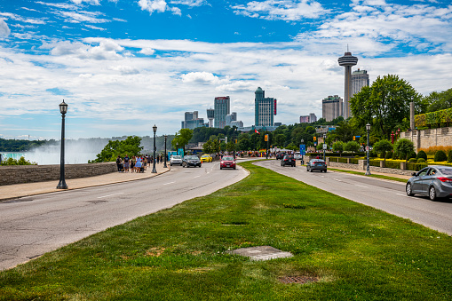 Niagara Falls, Canada - August 14, 2022: View along a street in Niagara Falls in Canada. On the left side is a part of the Niagara Falls visible.