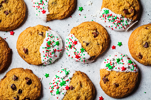 Christmas glazed cookies with festive sprinkles. Holiday dessert concept.