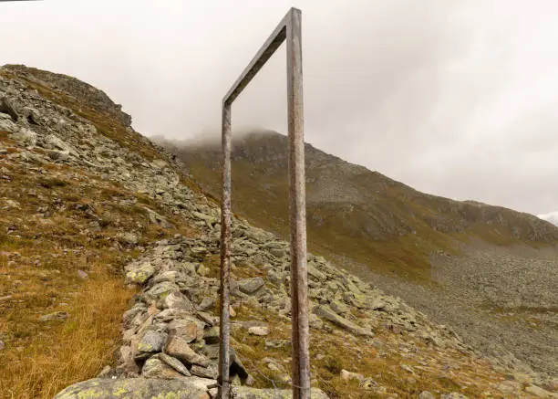 Photo of Metal frame and stone fence in the Austrian Alps. Austria, Salzburg, Gastein Valley