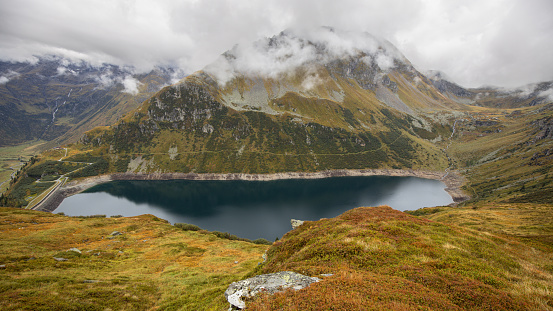 Alpine lake with clean clear water in the bowl of the Alpine mountains. Austria, Salzburg, Gastein Valley. High quality photo