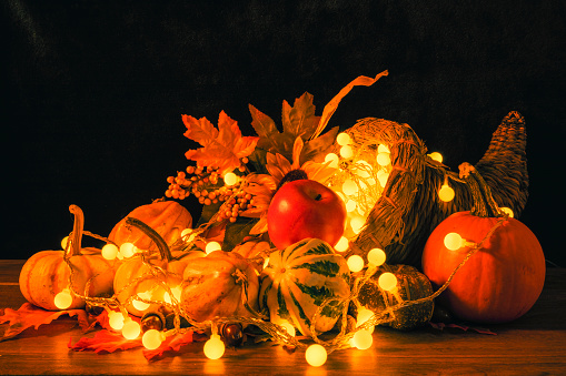 A cornucopia lit by festive holiday string lights