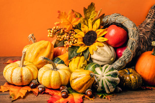 istock Overflowing Thanksgiving Cornucopia Centerpiece With Orange Background 1430418078