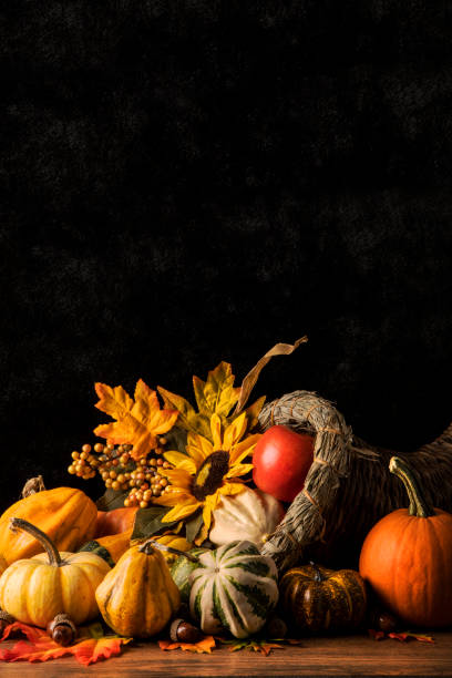 A close up of a cornucopia filled with festive gourds.