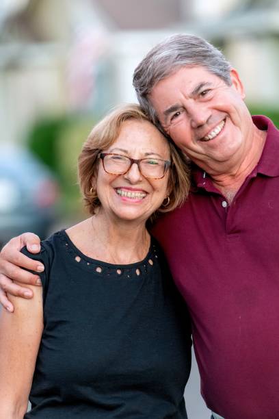 istock Smiling senior couple posing at their home front yard 1430418846