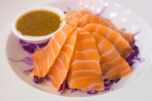 Plate with salmon on red cabbage with spicy sauce