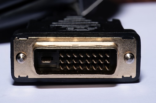 Close up photo of a DVI Display Connector. This connector is mainly used to transmit video data between two devices. These devices include Computers, Gaming Consoles, TVs and monitors.