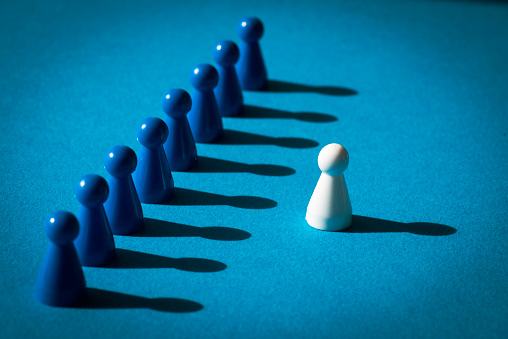 White and blue chess pieces over blue background.