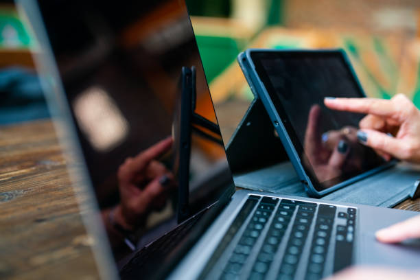 Businesswoman working on mobile devices out of office
