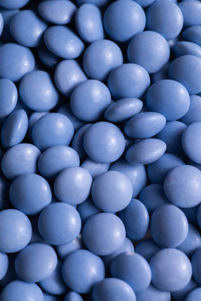 istock Close up of blue candy coated chocolate button sprinkle texture - M&Ms, Smarties, sprinkles 1430430499