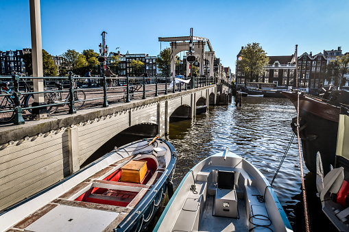 Boats Moored Near Magere Brug Drawbridge In Amsterdam, The Netherlands