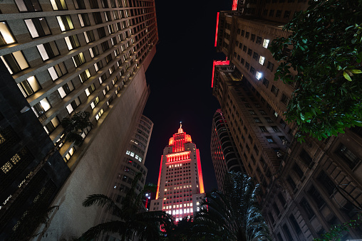 Sao Paulo, Brazil - July 25, 2022: Santander Lighthouse building illuminated with red light at night.