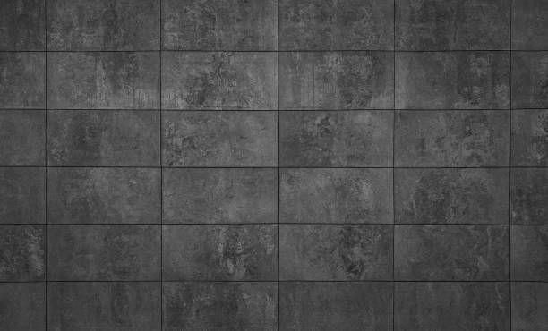 istock Black textured abstract background of tiled stone wall 1430435817
