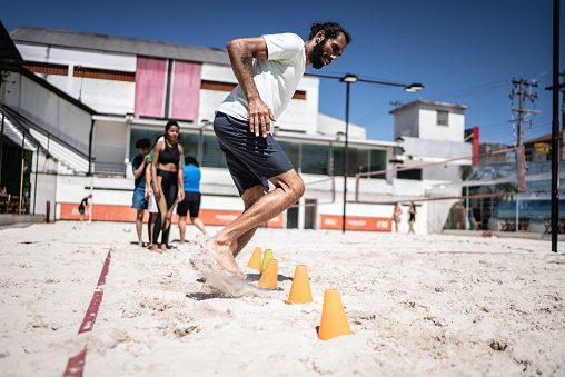 Man training in a sand court
