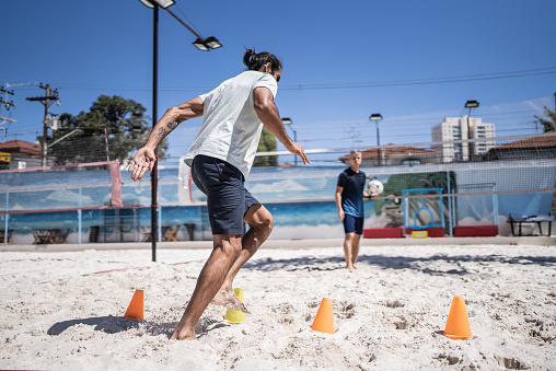 Man training in a sand court