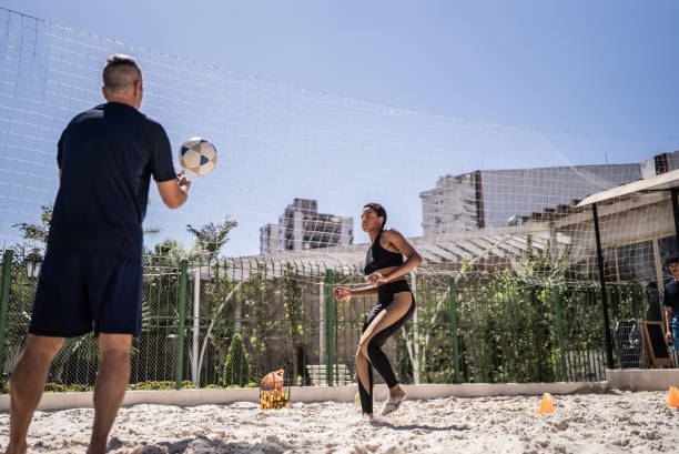 istock Instructor teaching a young woman in a footvolley class 1430438465