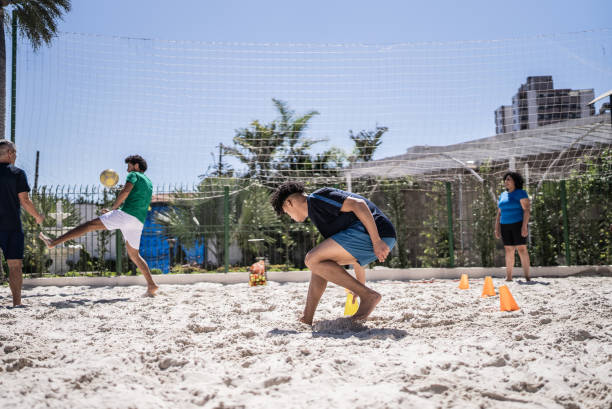 istock People doing warm up exercises in a footvolley class 1430438492