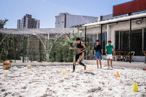 istock People doing warm up exercises in a footvolley class 1430438496