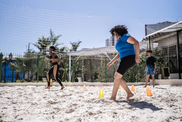 istock People doing warm up exercises in a footvolley class 1430438501