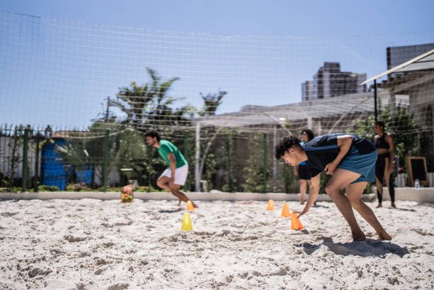 istock People doing warm up exercises in a footvolley class 1430438502