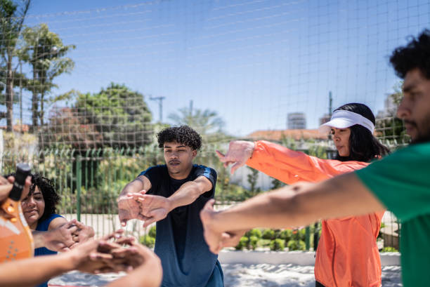 istock People stretching in a beach tennis court 1430438577