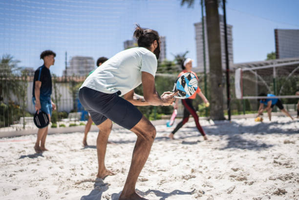 istock Mid adult man playing beach tennis 1430440628